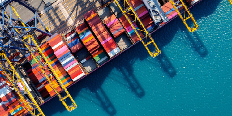 Metizoft to provide Strategic Marine Group with ESG application service, MTB Events, image shows aerial view of a cargo ship container harbour with colourful containers and bright blue sea