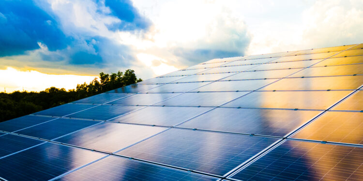 SUSI Partners holds final close for Southeast Asia Energy Transition Fund, SAETF, MTB Events, image shows rows of solar panels in the foreground, background has silhouettes of trees against the sunset