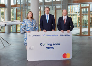 Lufthansa and Miles & More form a new alliance with Deutsche Bank and Mastercard, MTB events. Image shows members of each company holding a large replica of the Miles & More card