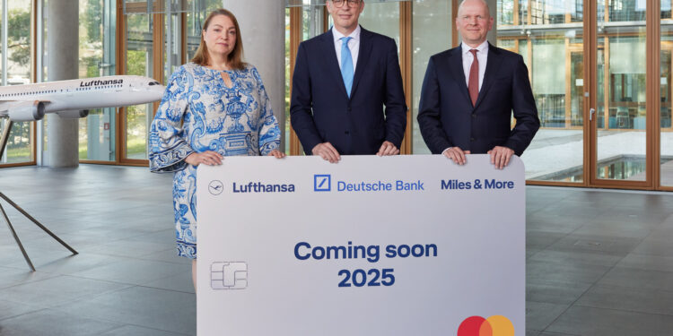 Lufthansa and Miles & More form a new alliance with Deutsche Bank and Mastercard, MTB events. Image shows members of each company holding a large replica of the Miles & More card