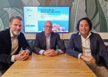 Ships Ink. & MPS Monitor Srl. announce exciting global maritime printing partnership, MTB events, Image shows from left to right: Ard Schalkwijk, Global Operations Manager at Ships Ink., Mark Kouwenberg, Sales Director at MPS Monitor Srl and Bart Mennega, Global Sales Manager at Ships Ink. All involved are at a wooden desk in front of a tv screen.