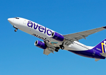 Avelo have begun their descent to San Juan, MTB Events, Image shows a plane in flight with the Avelo purple branding along the side