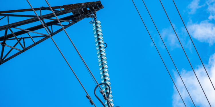 Ofgem have provisionally approved SSEN Transmission's proposals for Scotland, MTB News. Image shows a blue sky with thin power lines running across