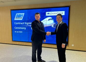 Three year deal agreed between B&H Worldwide and AFT, MTB Events. Image shows two men shaking hands in front of B&H Worldwide logo