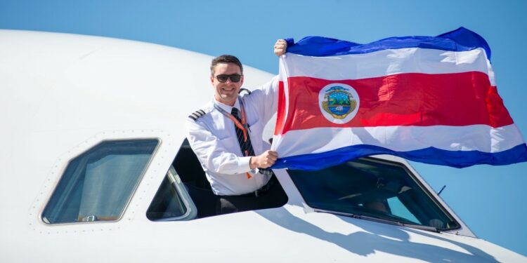 Tico the Sloth lands at Juan Santamaría International Airport, MTB Events. Image shows the pilot of the Tico the Sloth plane waving the Costa Rican flag