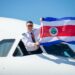 Tico the Sloth lands at Juan Santamaría International Airport, MTB Events. Image shows the pilot of the Tico the Sloth plane waving the Costa Rican flag