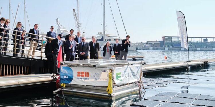 Further efforts to create 'responsible yachting' achieved by Yacht Club de Monaco, MTB Events. Image shows a group of people looking at the new technology on the water
