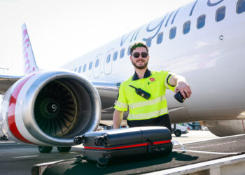 Significant expansion to Virgin Australia's revolutionary bag tracking tool, MTB Events. Image shows baggage handler scanning a bag outside a Virgin Australia bag