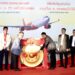 Vietjet celebrate new connections between Ho Chi Minh City with Vientiane, MTB Events. Image shows the ceremony with members of both airlines and cultural representatives of both countries banging a dong in front of a large Vietjet promotional image