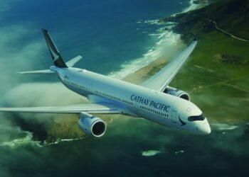In support of its 2050 net-zero objective, Cathay sets a new 2030 carbon intensity target, MTB Events. Image shows a Cathay Pacific aircraft flying over a green coast