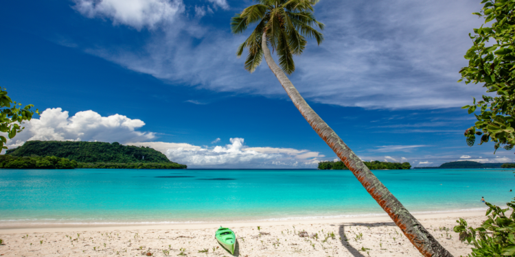 Direct flights to Vanuatu announced by Qantas and Jetstar, MTB Events. Image shows a beach with a green kayak and palm tree, Vanuatu.