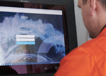 Lloyd's Register to become one of the largest software platforms with the acquisition of OTG, MTB Events. Image shows a person in orange high vis jacket looking at a computer screen with the Ocean Technologies software on. Image sourced from Ocean Technologies Group.