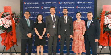 Image shows six people in front of a sign of AD PORTS GROUP and noatum logistics and flowers. AD Ports Group Opens First International Office in China, Signalling Key Step in Global Growth Strategy, MTB Events.