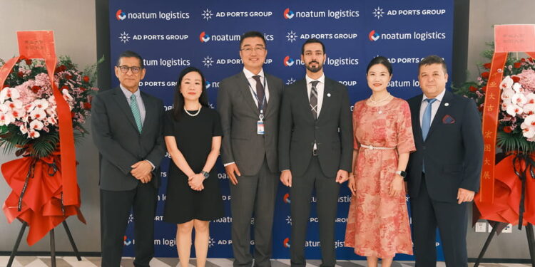 Image shows six people in front of a sign of AD PORTS GROUP and noatum logistics and flowers. AD Ports Group Opens First International Office in China, Signalling Key Step in Global Growth Strategy, MTB Events.