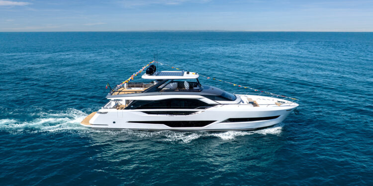 Image shows the Ferretti Yachts 800 at sea with rows of flags from the front to back. Ferretti Yachts Unveils the First Unit of the New 800 Model, MTB Events.