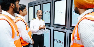 Image shows 4 men in orange jackets - Seafarer training on alternative fuels: the new methanol bunkering simulator from Wärtisä at BSM's Maritime Training Centre in Kochi ©BSM. BSM Unveils First Methanol Bunkering Simulator at Kochi Training Centre in Collaboration with Wärtsilä, MTB Events.