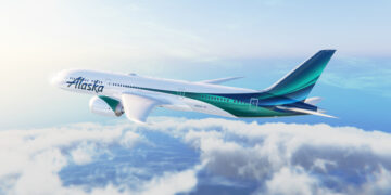 Image shows an Alaska Airlines plane with green and blue stripes on the fuselage flying in the sky with clouds below. Alaska Airlines Expands International Reach with New Routes to London and Reykjavik, MTB Events.