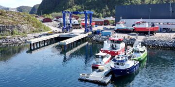 Image shows a small dockyard with workboat vessels and a blue lift. Damen and Folla Maritime launch Damen Folla at Aqua Nor, MTB Events.
