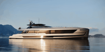 Image shows a beige 46 meter superyacht on water with a mountain in the background. Van der Valk Begins Construction on 48-Metre Flagship “Project ZEN”, MTB Events.