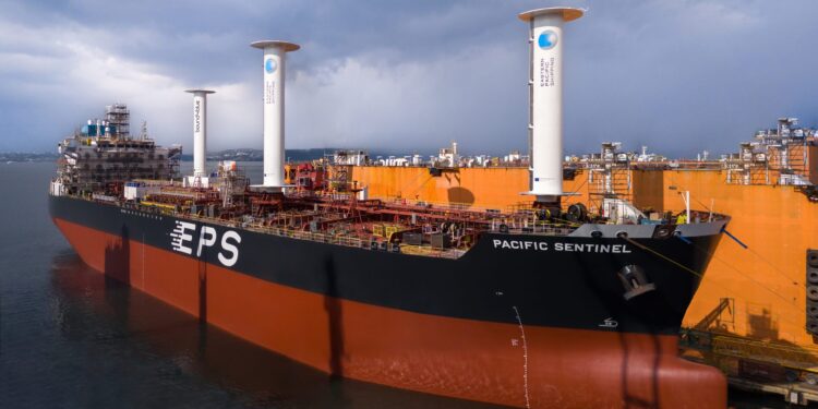 Image shows the wind powered vessel in a port alongside an orange wall during the day. Sailing Toward a Cleaner Future: bound4blue Lands Landmark Investment to Scale Innovation, MTB Events.