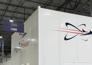 Image shows inside a warehouse building with a large white wall with the text Flight Power, alongside their logo. A Visit to Flight Power’s Plant 98 — Reflections from Holly, MTB Events, MTB Events.