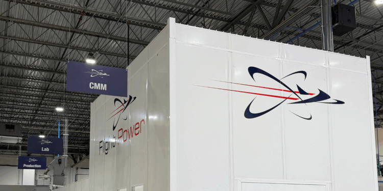 Image shows inside a warehouse building with a large white wall with the text Flight Power, alongside their logo. A Visit to Flight Power’s Plant 98 — Reflections from Holly, MTB Events, MTB Events.