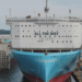 Image shows a large ship in a shipyard surrounded by cranes and machinery, on the front of the ship reads the words "All the way to Zero". HD Hyundai and Palantir Scale AI Platforms Across Global Operations, MTB Events.
