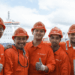 Image shows five crew members in orange jumpsuits and hard hats, at a port. Albireo, a New Crewing Venture Established by Harren Group and NSB Group, MTB Events.