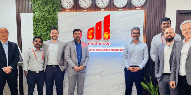 Image shows eight men standing in front of a sign with the motherson logo on it. Embraer Signals Long-Term Commitment to India’s Aerospace Ecosystem, MTB Events.