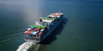 Image shows a container ship at sea. Eutelsat and Can Marine Join Forces to Enhance Maritime Connectivity with OneWeb LEO, MTB Events.