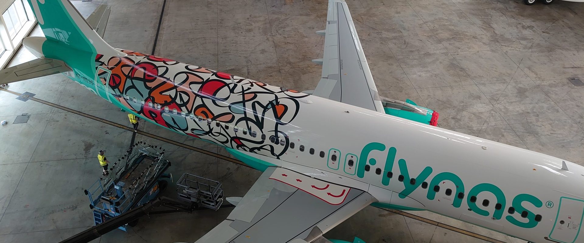7 of the most unusual and impressive aircraft liveries, MTB Events. Image shows Flynas aircraft with colourful pattern made from the 'Year of Arabic Calligraphy' logo.